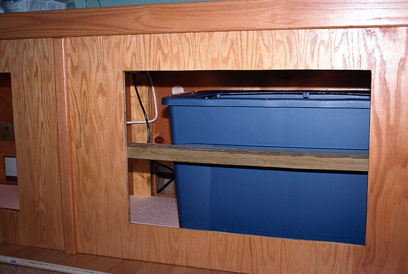 Sump container installed in cabinet